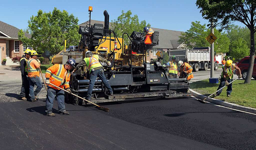 UTE Crew doing a commercial paving job for local business owner